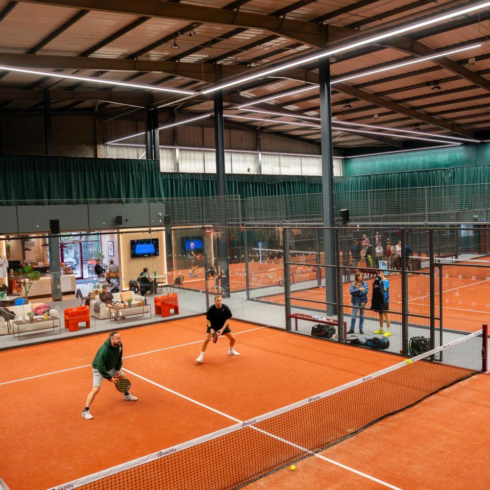 Wide view of the Performance Padel clubhouse and courts fitted with acoustic curtains