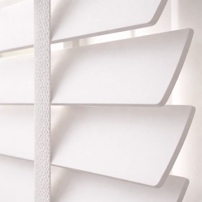 Close up of plain white venetian blinds with white ladder tape