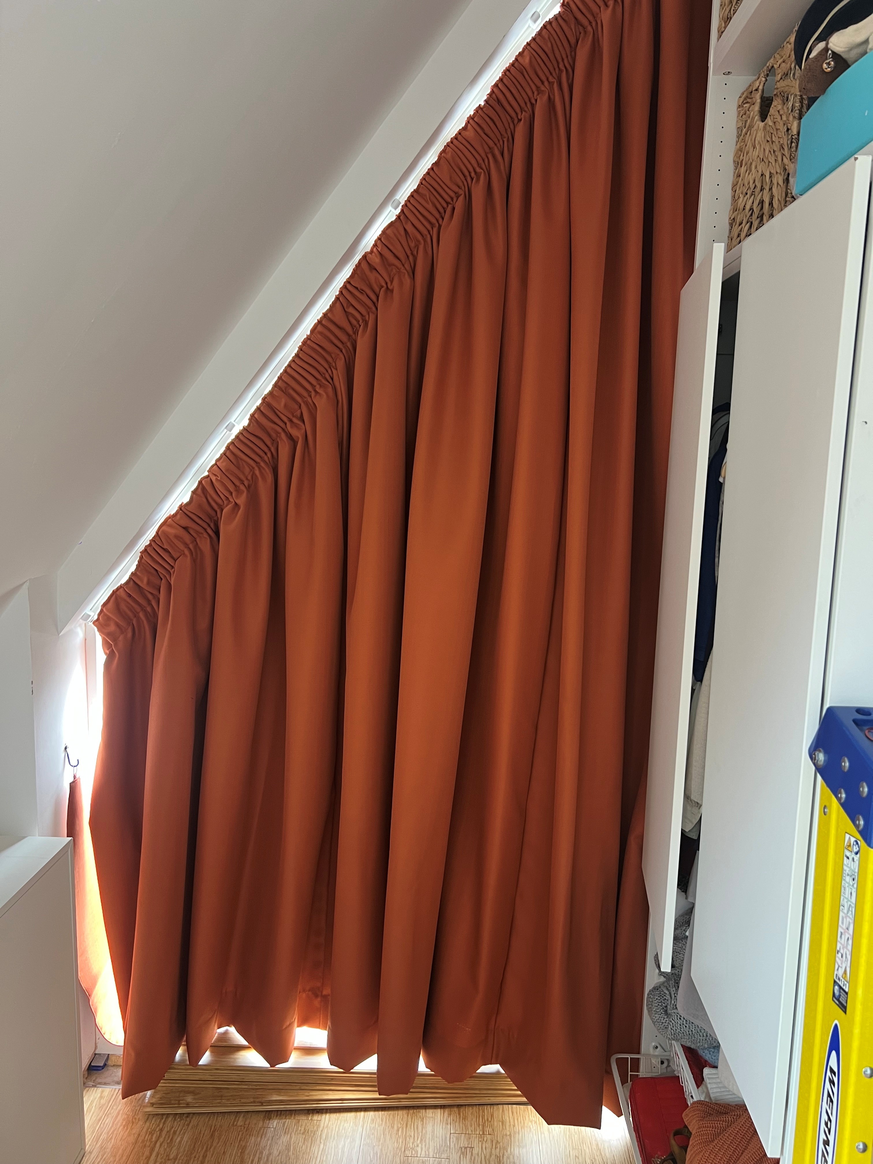 Made to measure triangular curtain with 3 inch pencil pleat heading on a sloped slimline ceiling track